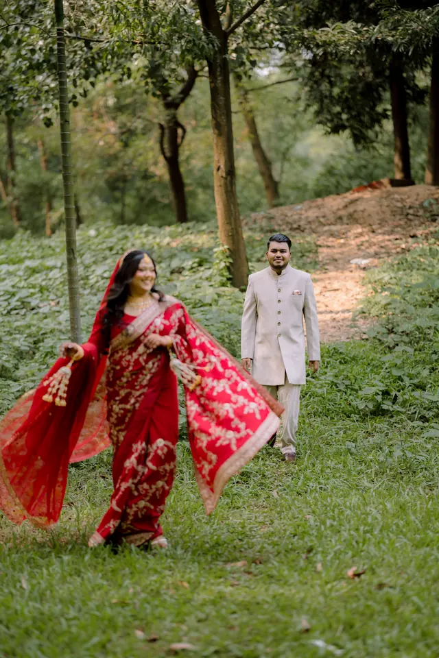 Samira walking toward Nahin in a green garden